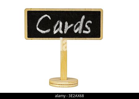 Rustic wooden stand holding a small blackboard with handwritten white chalk text reading Cards, isolated on a clean white background with ample copy s Stock Photo