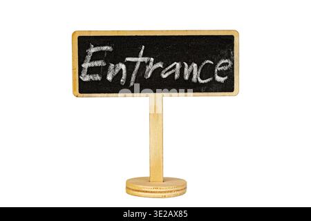 Handwritten white chalk text reads Entrance on a dark blackboard sign with wooden frame and round base stand, isolated on white background with copy s Stock Photo
