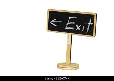 Miniature wooden stand blackboard sign with handwritten chalk Exit lettering and directional arrow isolated on white background, offering copy space f Stock Photo