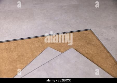 stone texture vinyl tile flooring installation Stock Photo