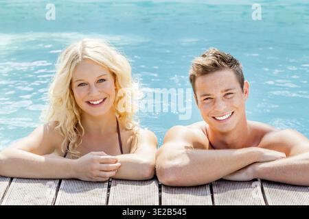 A young attractive couple, 30 years old, relaxing at the swimming pool, man, woman, blonde, blonde, Federal Republic of Germany Stock Photo