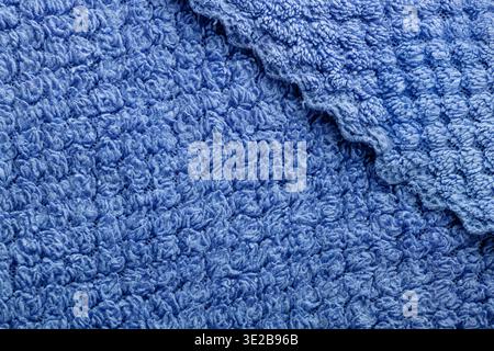 Close-up of soft blue towel fabric with rich texture, suitable for backgrounds, spa, hygiene, and home decor concepts. Stock Photo