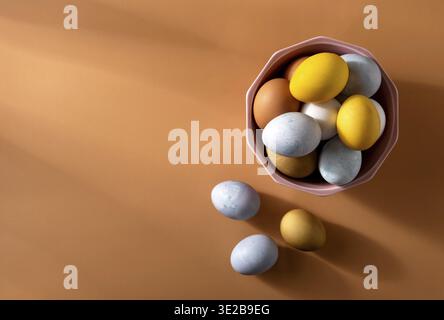 Naturally dyed easter eggs on beige background. Eco concept. Organic natural easter concept. Modern easter eggs painted with natural dye in different Stock Photo