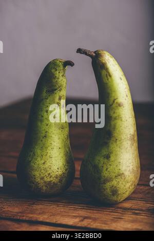 Food, Still Life with Two Green Pears on Wooden Table Stock Photo