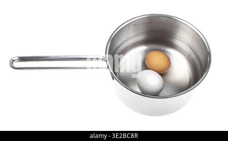 Two eggs in saucepan with water isolated on white background Stock Photo