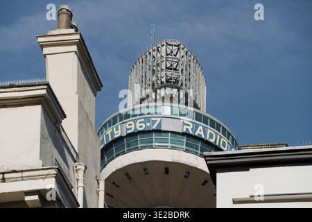 Contrasting architecture with the Victorian chimney set against the St. John's market beacon tower. Stock Photo