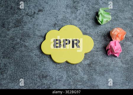 Concept of BPR - Business Process Re-engineering write on sticky notes isolated on Wooden Table. Stock Photo