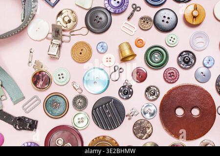 Top view of many various sewing items on pink background Stock Photo