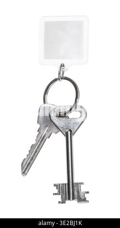 Steel keys on keyring with blank keychain isolated on white background Stock Photo