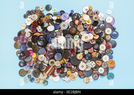 Top view of heap of many various buttons on blue background Stock Photo
