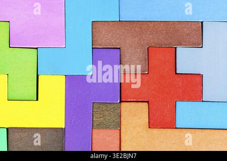 Top view of assembled puzzle from colored wooden pentominoes and blocks Stock Photo