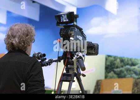 Berlin, Germany - January 22, 2024: Camera operator is filming a scene with professional equipment in a studio setting Stock Photo
