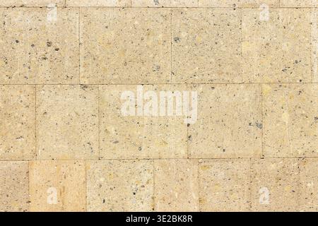 Polished armenian light brown tuff stone tiles on wall of house in Etchmiadzin, Vagharshapat city, Armenia Stock Photo