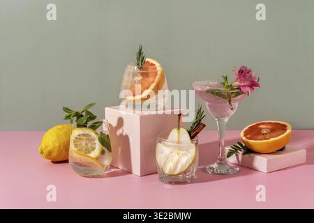 Hard seltzer cocktails with various fruits: pear, grapefruit, lemon. Refreshing colorful summer drinks on green background Stock Photo