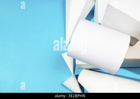 Top view of various hand-crafted paper geometric solids close up on turquoise blue background with copyspace Stock Photo