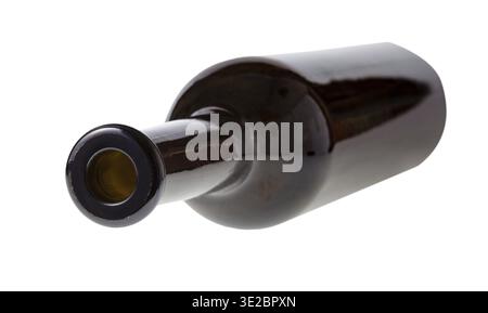 Overturned empty dark brown wine bottle isolated on white background Stock Photo