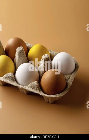 Naturally dyed easter eggs on beige background. Eco concept. Organic natural easter concept. Modern easter eggs painted with natural dye in different Stock Photo