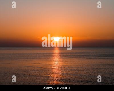 Aerial sunset over Baltic Sea horizon near Latvian coast, calm water Stock Photo