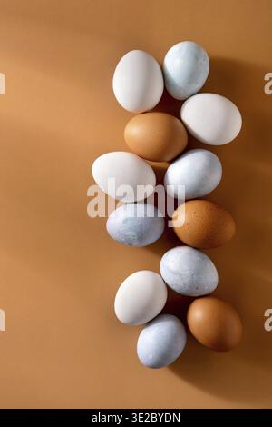 Naturally dyed easter eggs on beige background. Eco concept. Organic natural easter concept. Modern easter eggs painted with natural dye in different Stock Photo