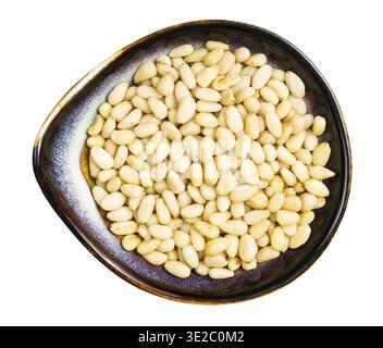 Top view of shelled pine nuts in ceramic bowl isolated on white background Stock Photo