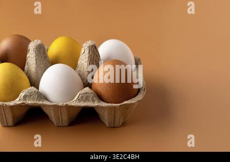 Naturally dyed easter eggs on beige background. Eco concept. Organic natural easter concept. Modern easter eggs painted with natural dye in different Stock Photo