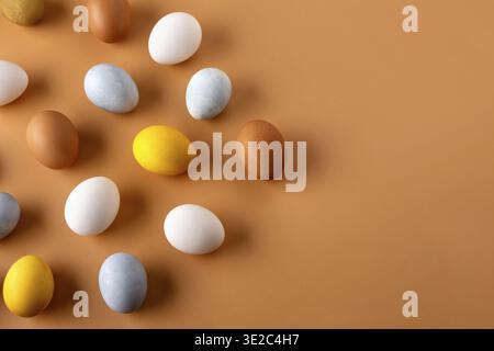 Naturally dyed easter eggs on beige background. Eco concept. Organic natural easter concept. Modern easter eggs painted with natural dye in different Stock Photo