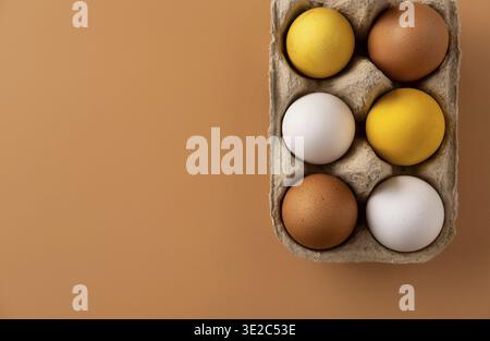 Naturally dyed easter eggs on beige background. Eco concept. Organic natural easter concept. Modern easter eggs painted with natural dye in different Stock Photo