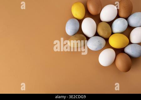 Naturally dyed easter eggs on beige background. Eco concept. Organic natural easter concept. Modern easter eggs painted with natural dye in different Stock Photo