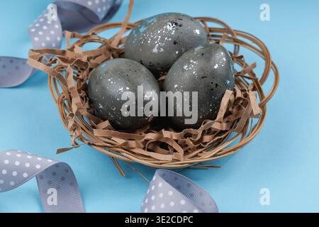 Speckled Easter eggs with silver texture in nest Stock Photo