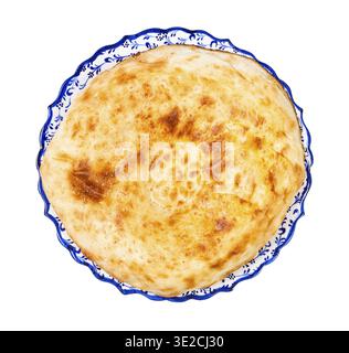 Top view of freshly baked tandoor uzbek bread (Obi non) on ornamental plate isolated on white background Stock Photo