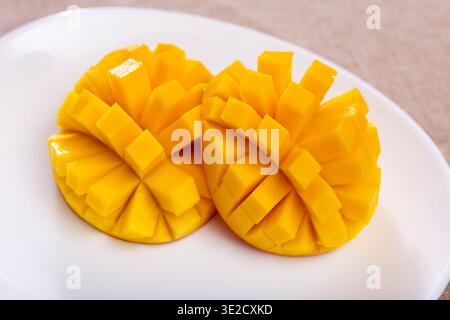 Deliciously served fresh mangoes diced and laid out on plate Stock Photo