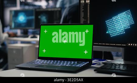 Data center engineer working on neural network software development on chroma key laptop. Server room IT specialist implementing machine learning technology using isolated screen notebook, camera A Stock Photo