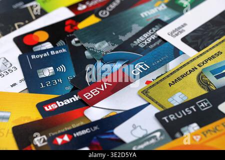 KYIV, UKRAINE - JANUARY 28, 2026 Big pile of credit cards with logos of various banks of whole world. Concept of credit or debit cards usage. Banking, Stock Photo