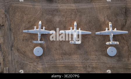 Tucson, United States - 30 January 2025: Aerial view of three decommissioned aircraft, stark against the arid desert landscape, their ghostly white fo Stock Photo