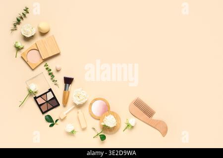 Frame made of white rose flowers and makeup products on beige background Stock Photo