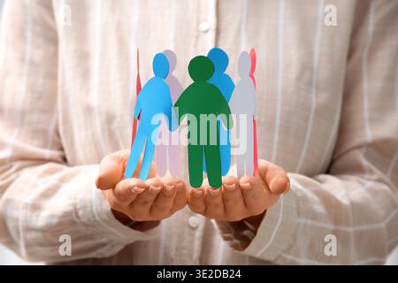 Woman with paper human figures, closeup. Inclusion concept Stock Photo
