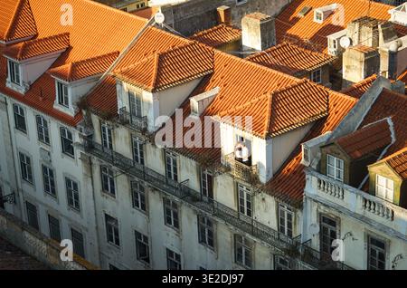 A couple standing on a balcony in Baixa district of Lisbon, Portugal Stock Photo