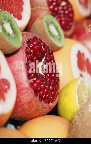 Fruits arranged for display with focus on pomegranate Stock Photo