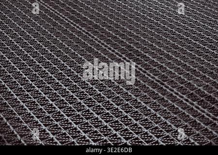 A black and white photo of a metal mesh with a lot of small squares Stock Photo