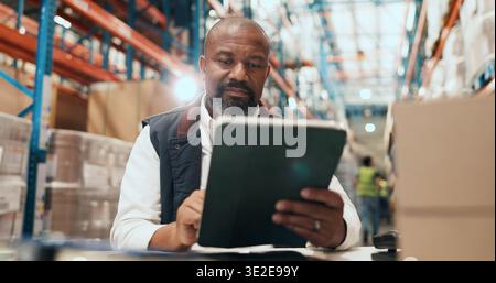 Logistics, man and scroll on tablet in warehouse for order tracking, shipping status or distribution. Supply chain, mature manager or tech for stock Stock Photo