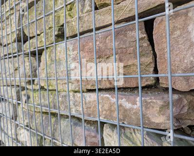 Closeup Gabion Cage With Stone, Tight Wire Mesh Enclosing Stacked Blocks With Visible Fractures And Rust Accents, Structural Detail Used In Civil Engi Stock Photo