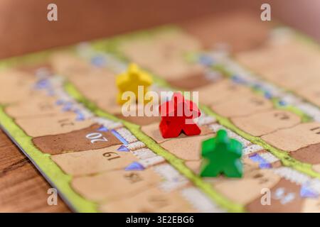 Colored game figures chips for board games. Collection of dice cubes on green table Stock Photo