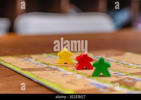Colored game figures chips for board games. Collection of dice cubes on green table Stock Photo