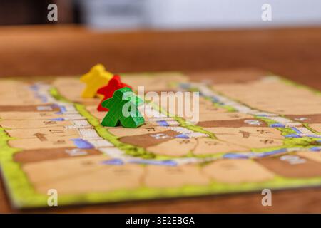 Colored game figures chips for board games. Collection of dice cubes on green table Stock Photo