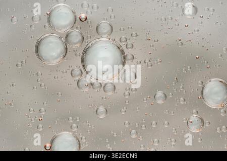 Oil and water macro composition: translucent bubbles and spheres forming an abstract fluid texture of separation, light and motion. Photography, no ge Stock Photo