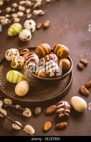 Sweet chocolate eggs with cocoa beans in brown tone for Easter Stock Photo