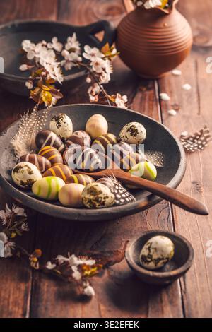 Easter place setting with sweet chocolate eggs, spring celebration Stock Photo