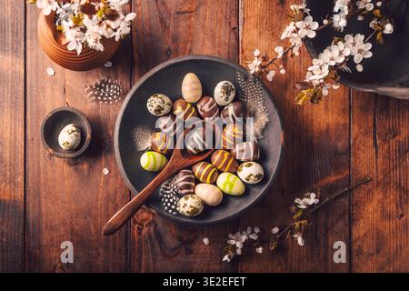 Easter place setting with sweet chocolate eggs, spring celebration Stock Photo