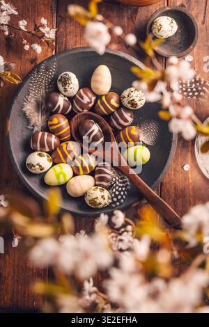 Easter place setting with sweet chocolate eggs, spring celebration Stock Photo
