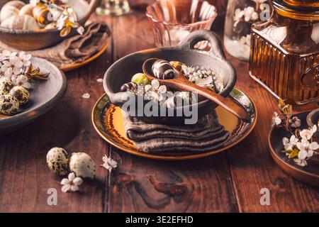 Easter place setting with sweet chocolate eggs, spring celebration Stock Photo